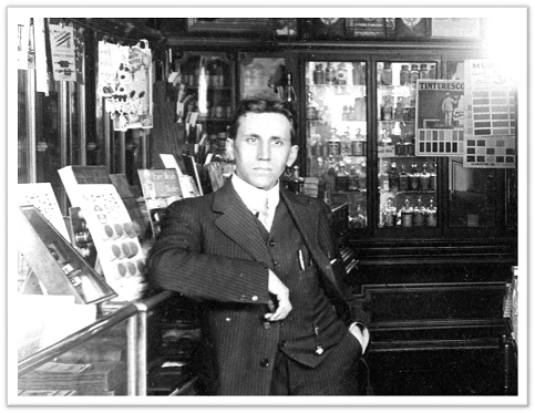 Louis Oswald Early 1900s. Photograph of Louis Oswald working at Oswald's Pharmacy in the early 1900s.