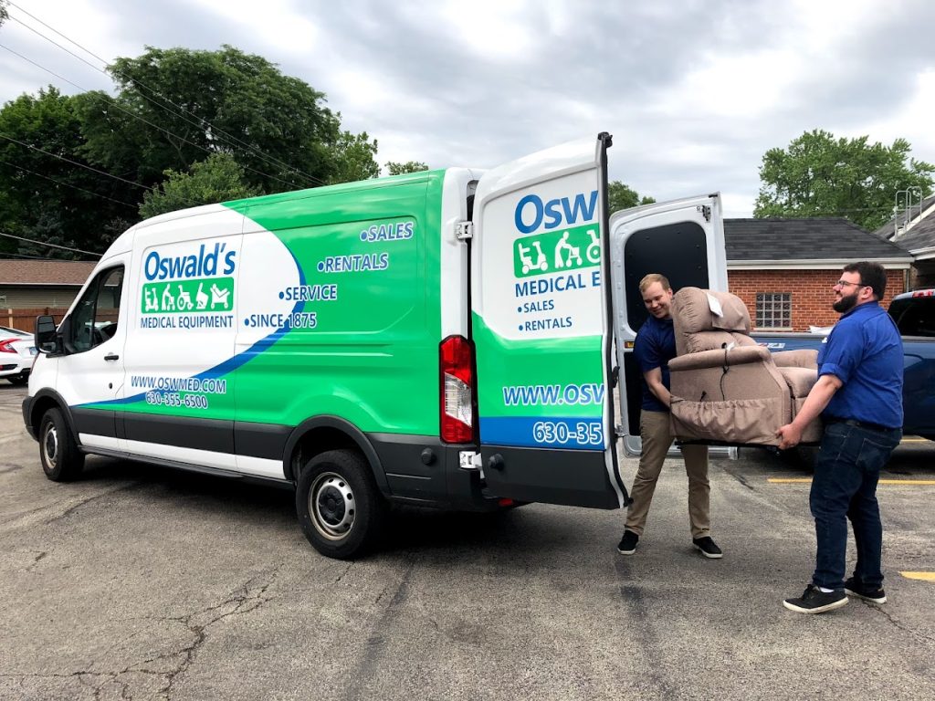 Lift Chair Delivery image. Photo of two Oswald's employees loading a lift chair onto a delivery van.