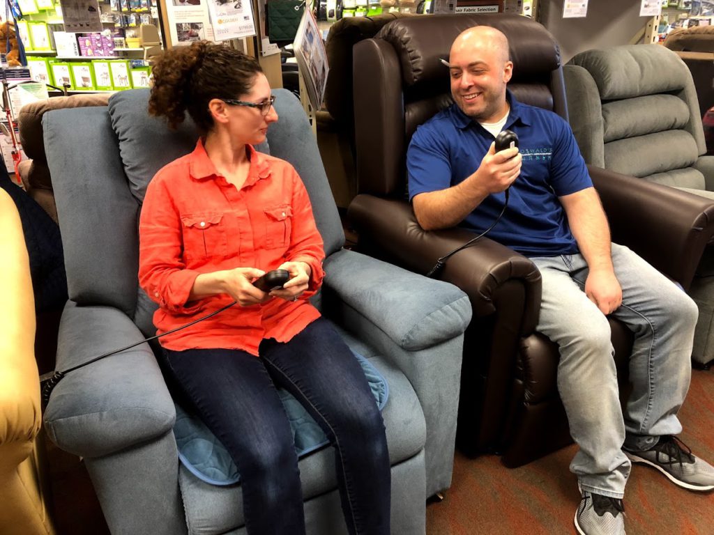 Lift Chair Experts image. Photo of an Oswald's employee showing a customer how lift chairs work.